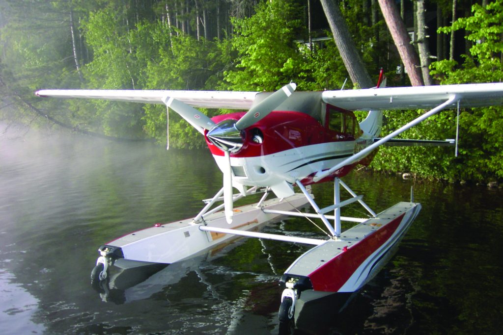 Red float plane with 3-blade Hartzell propeller