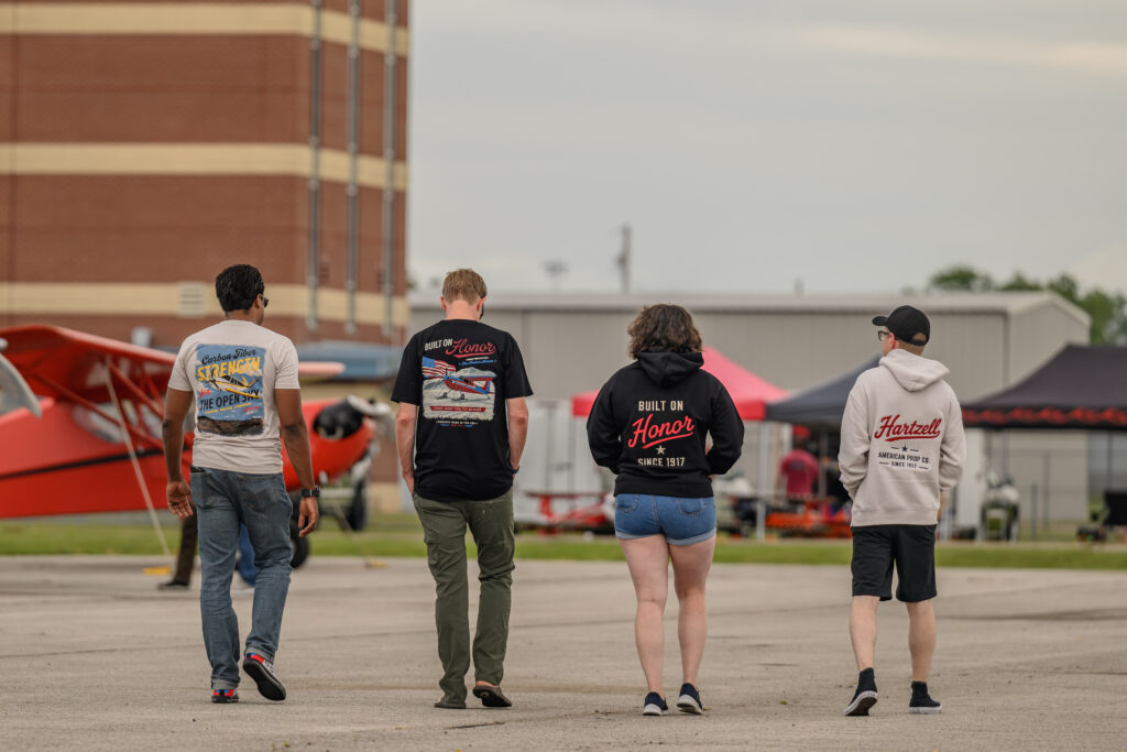 Four individuals from behind wearing Hartzell Merch