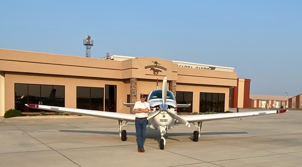 Pilot Jim Peitz with his Beechcraft Bonanza in front of Mustang Aviation