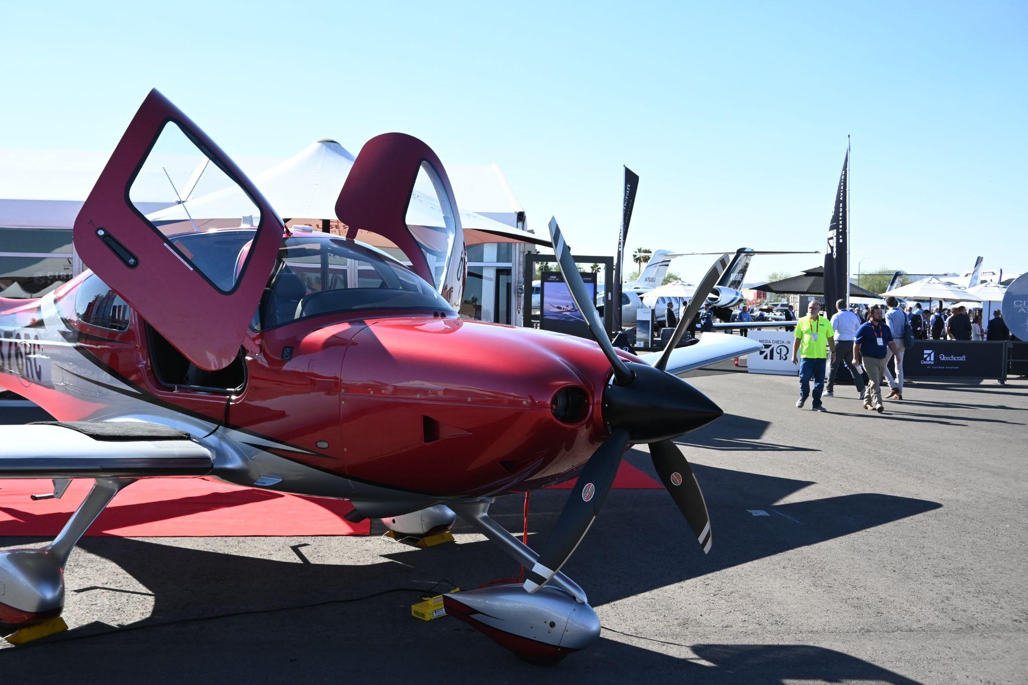 Red aircraft with composite hartzell propeller at NBAA 2023